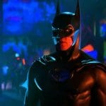 **Resumo:** *Batman Eternamente* (1995), dirigido por Joel Schumacher, abandonou o tom sombrio da franquia por um visual kitsch, com vilões exagerados e cenários neon. Val Kilmer interpretou um Bruce Wayne introspectivo. Apesar de críticas mistas, foi sucesso comercial e hoje é um ícone pop dos anos 90. (50 palavras)